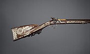 Cased set of a flintlock rifle, a pair of pistols, and accessories