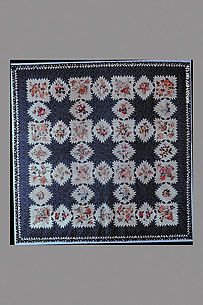 Feathered Star pattern quilt with chintz appliques