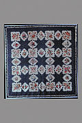 Feathered Star pattern quilt with chintz appliques