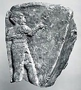 Fragment of a trough with a nude male figure in relief