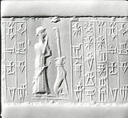 Cylinder seal: male worshiper, dog surmounted by a standard