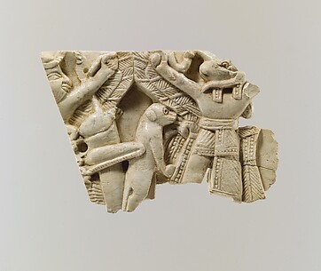 Plaque fragment with a monkey and a locust between a winged figure and ram-headed figures