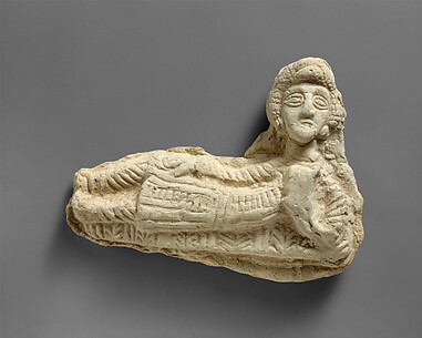 Plaque in the form of a reclining woman