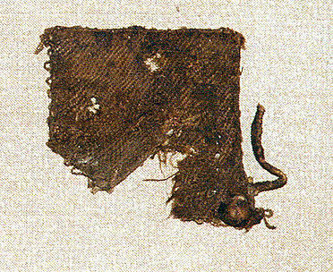 Small textile square with leather tie in corner