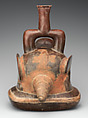 Cupisnique Artist S Stirrup Spout Vessel With Figure In A Shell