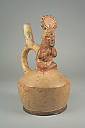 Stirrup spout bottle with figure