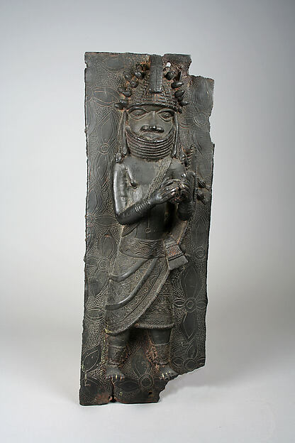 Plaque: Titleholder with Calabash Rattle