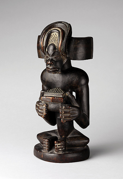 Commemorative figure of a chief playing a sanza (thumb piano)