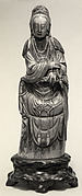 Seated Figure of Guanyin on Rock Base with Carved Armrest