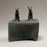 Two cats surmounting a box for an animal mummy