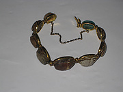Nine scarabs set in modern bracelet.