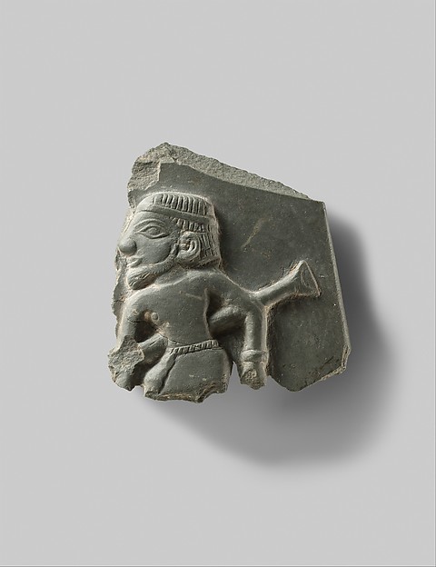 Fragment of a ceremonial palette illustrating a man and a type of staff