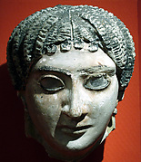 Mask of a woman with radiating waves of hair