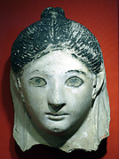 Mask of a woman with her hair in a small knot