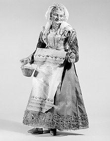 Old woman carrying a wire basket