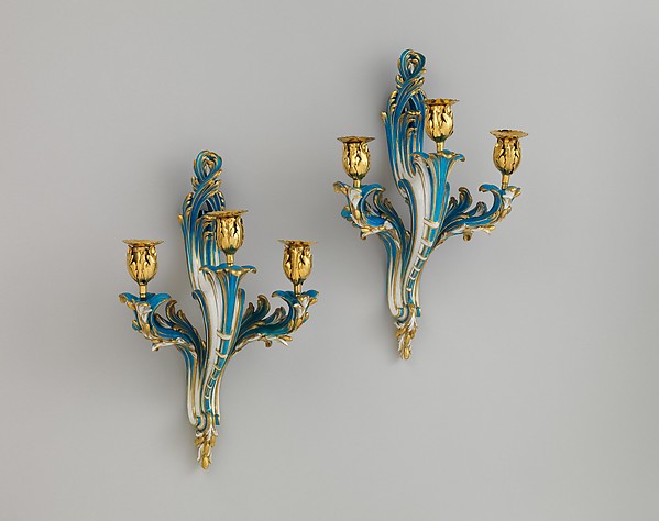 Pair of three-light wall sconces