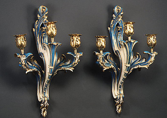 Pair of three-light wall sconces