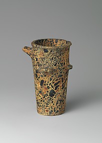 Reproduction of a tall spouted breccia stone vase