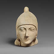 Limestone head of a beardless male wearing a conical helmet