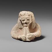 Upper part of a limestone male aulos player
