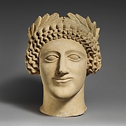 Limestone head of a youth with wreath