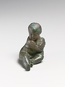 Bronze statuette of a child with a bunch of grapes