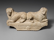 Limestone finial of a funerary stele with two recumbent lions