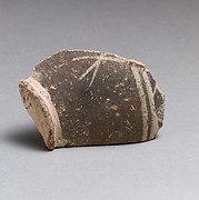 Terracotta base of a small vase with linear decoration