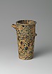 Reproduction of a tall spouted breccia stone vase