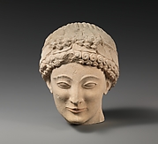 Limestone beardless male head with ivy wreath