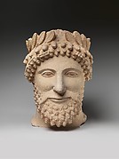 Limestone head of a bearded man wearing a wreath