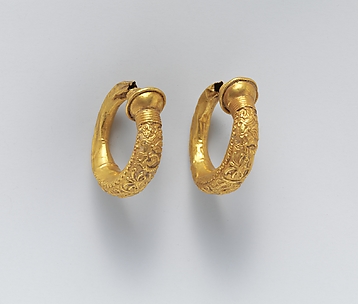 Gold trumpet-shaped earrings with relief decoration