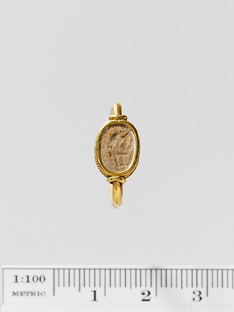 Steatite scaraboid seal set in a gold swivel ring