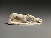 Limestone statuette of a coursing hound seizing a hare