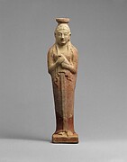 Terracotta alabastron (perfume vase) in the form of a woman holding a dove