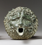 Bronze water spout in the form of a lion mask (one of a pair)