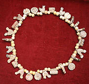Necklace with bird, circle and cylinder beads