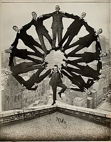 [Man on Rooftop with Eleven Men in Formation on His Shoulders]