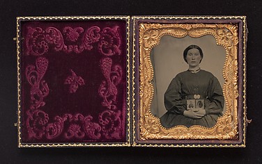 [Woman Holding Cased Portraits of Civil War Soldiers]
