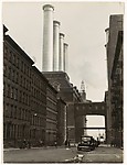 [City Street Ending at Factory with Four Smokestacks]