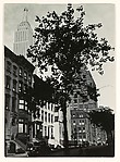 [Empire State Building above Brownstone Buildings]