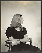 [Woman in Scarf Seated in Chair]