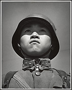 A fifteen-year-old stands at attention before his company leaves for the front and the decisive Sino-Japanese battles of the year. Hankow, March