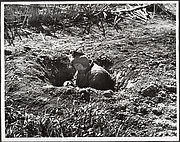 His own garden provides this man with an air raid shelter, Hankow