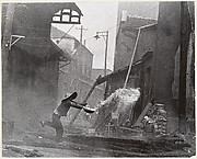 After incendiary bombardments, a woman tries futilely to extinguish the fire. Hankow