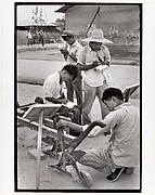 Visitors take notes on a peasant invention at National Farm Implements Exhibit, Peking
