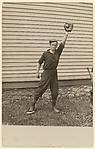 [Man with Outstretched Arm in Front of House, Holding Baseball in Catcher's Mitt]