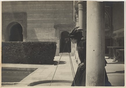 [View of a Courtyard with a Woman (Olga?) Looking Through a Camera on a Tripod]