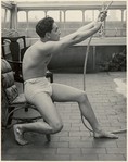 [Male Model Posed Pulling a Rope in Anna Huntington's Rooftop Studio]