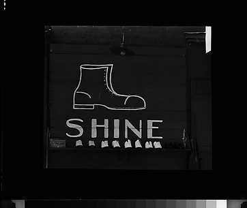 [Shoeshine Sign and Display on Wall]